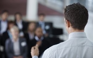 Rear view of a professor speaking at a conference