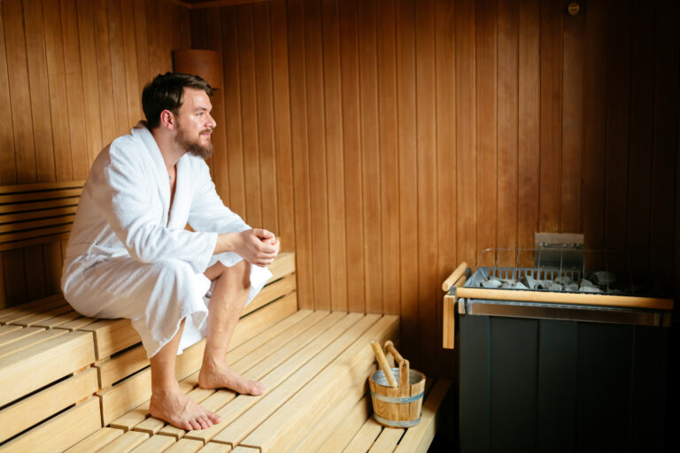 Handsome man relaxing in sauna