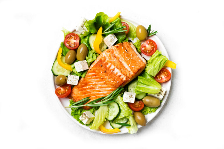 Greek salad and salmon fish steak
