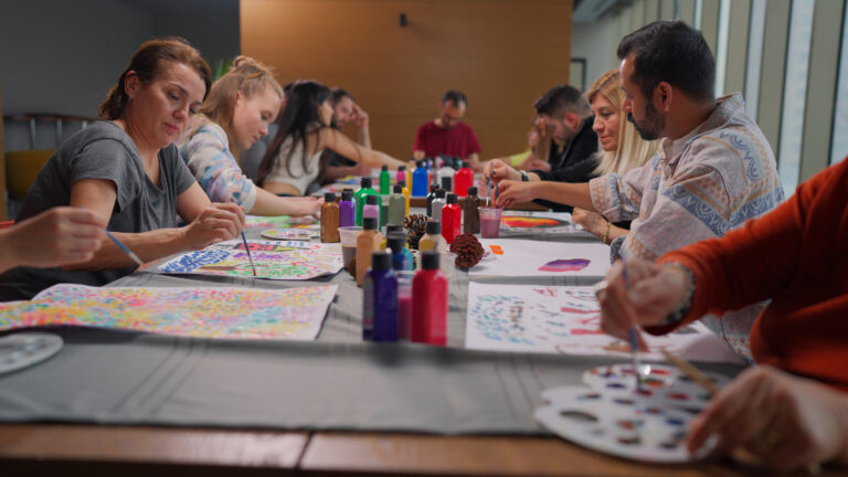 Group of multi-racial people with different ages joining art painting therapy session class