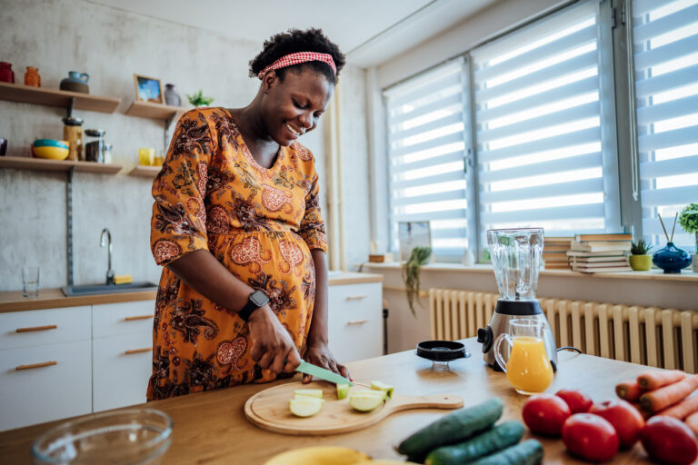 Pregnant woman preparing a healthy breakfast at home